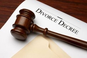 A gavel and a paper with DIVORCE DECREE words