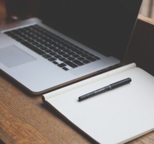 laptop and a notebook on a table