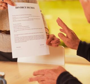 Female hands holding divorce paper