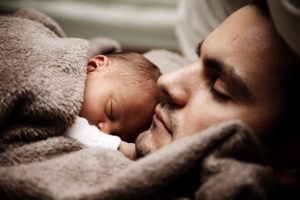 a dad holding a new baby, family law attorney