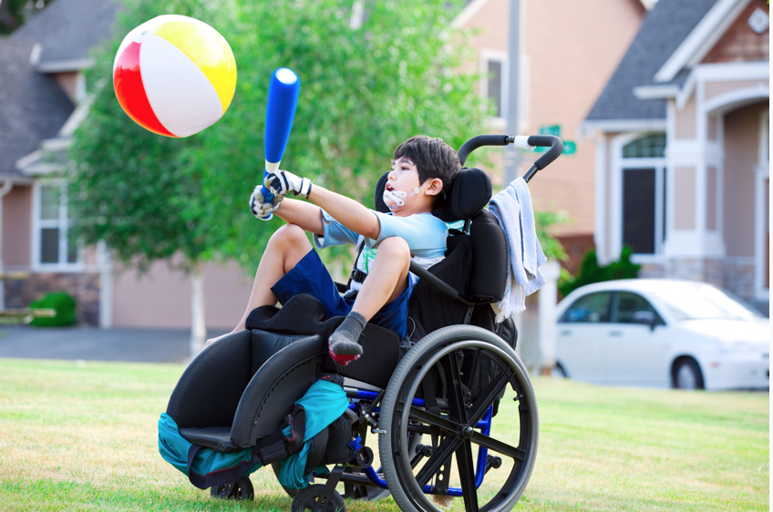 A child in a wheelchair playing