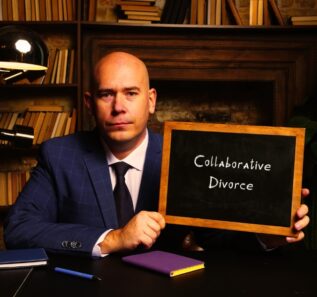 Hand holding chalkboard with phrase Collaborative Divorce
