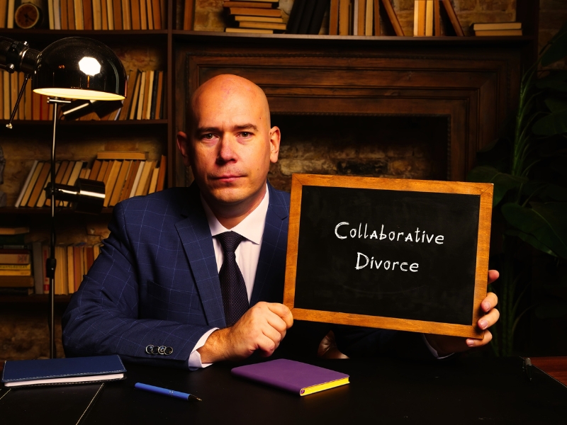 Hand holding chalkboard with phrase Collaborative Divorce