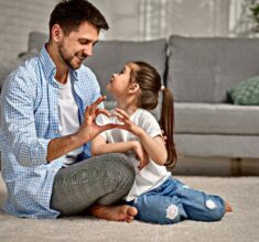 handsome father and cute little child daughter showing love sign. dad and girl kid make hand heart gesture. Happy Father's day.