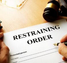 a person filling out a restraining order