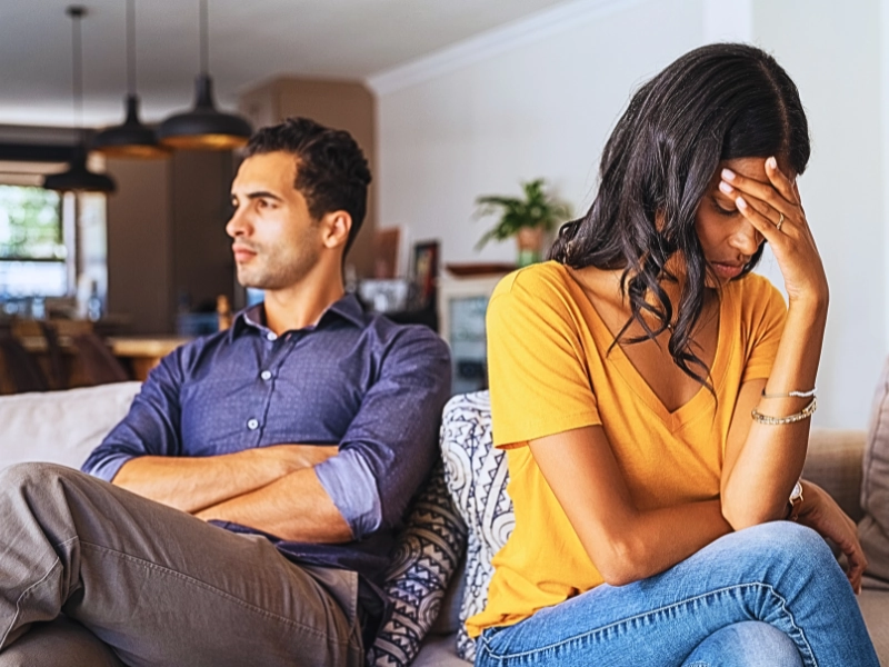 Young couple sitting on couch after a fight. date during a divorce