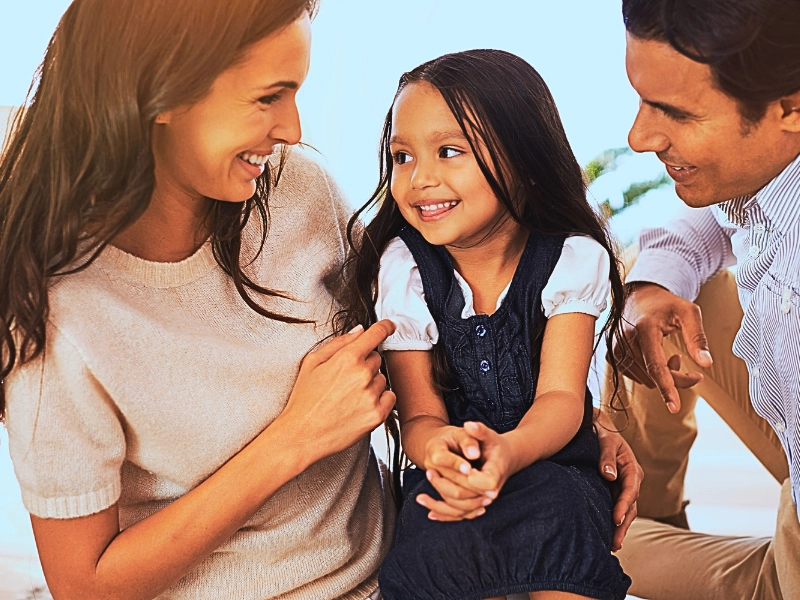 Happy mother, father and daughter playing at home. Updating Your Parenting Plan for School