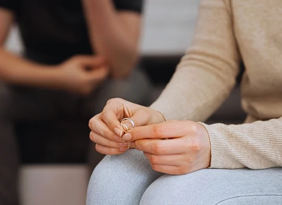 a close-up of a person holding two wedding rings, suggesting a moment of separation or divorce. Get Divorced Without Going to Court