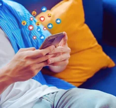 A man using his phone cheking his social media post.